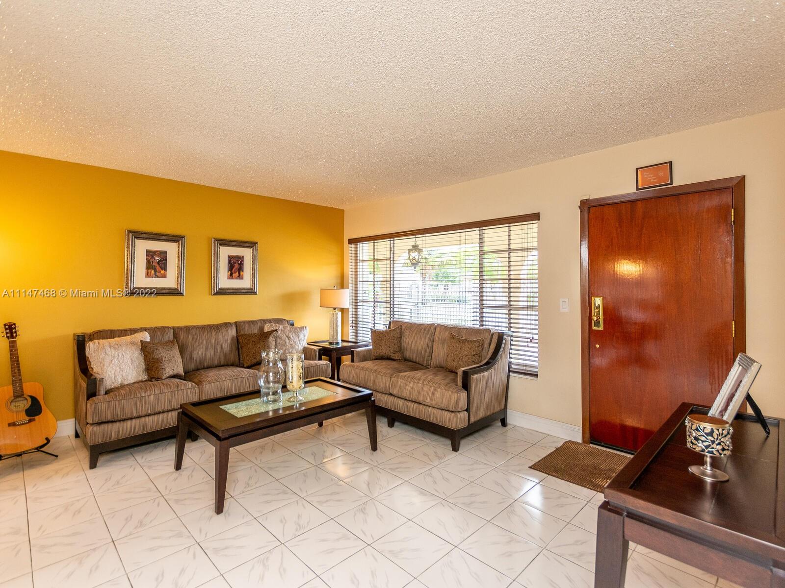 490 West 33rd Place Hialeah, FL 33012 - Photo 10 of 88 a living room with furniture and a flat screen tv