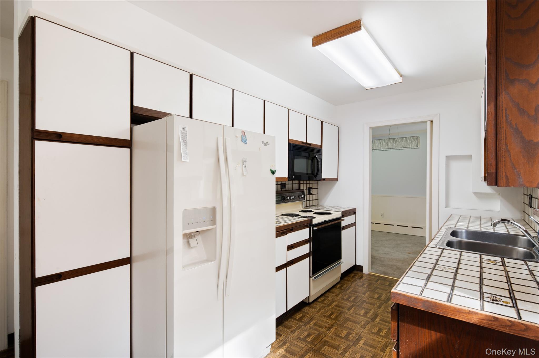 28 Alice Road Mount Kisco, NY 10549 - Photo 15 of 32 a kitchen with stainless steel appliances granite countertop a refrigerator stove and microwave