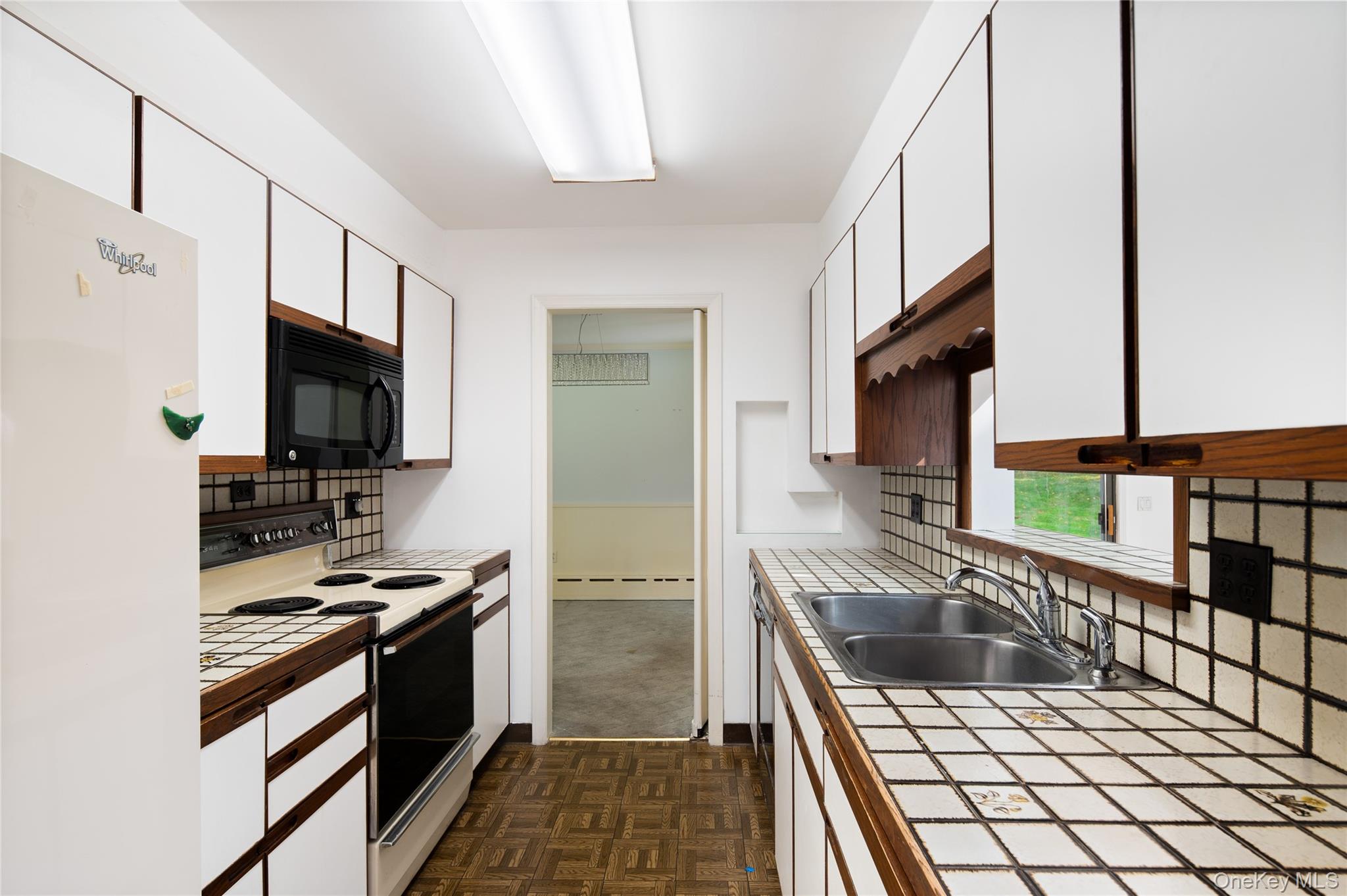 28 Alice Road Mount Kisco, NY 10549 - Photo 16 of 32 a kitchen with granite countertop a sink and a stove top oven