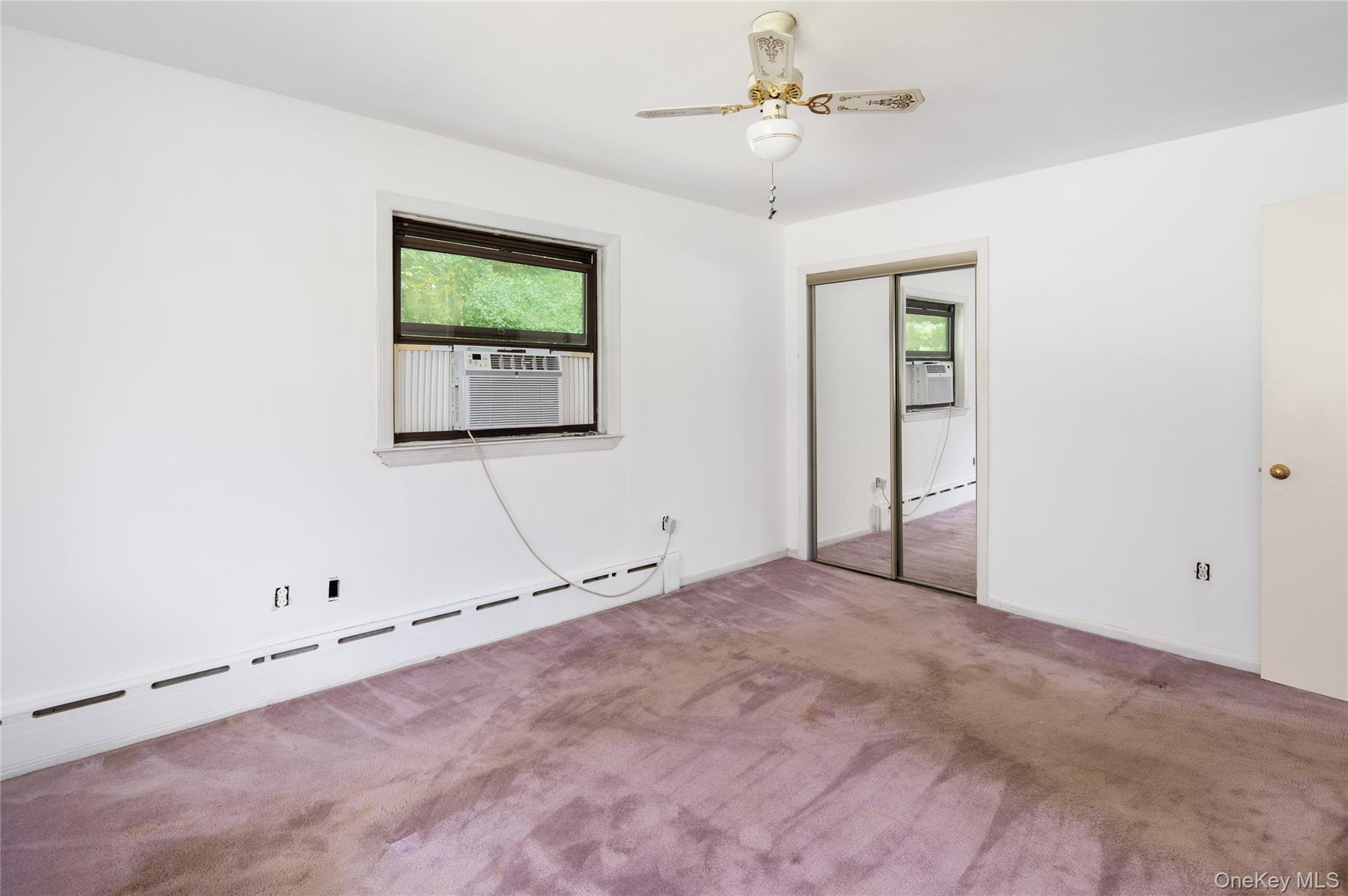 28 Alice Road Mount Kisco, NY 10549 - Photo 18 of 32 an empty room with window and ceiling fan