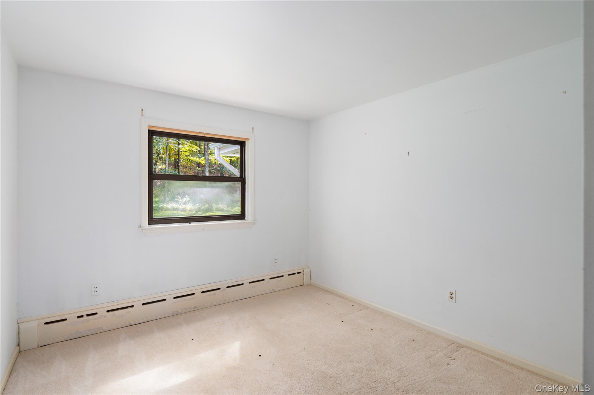 28 Alice Road Mount Kisco, NY 10549 - Photo 20 of 32 an empty room with a window