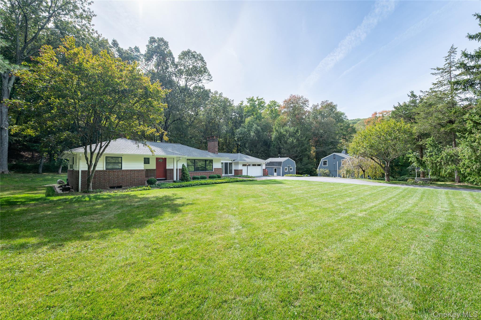 28 Alice Road Mount Kisco, NY 10549 - Photo 29 of 32 a white house with a big yard plants and large trees
