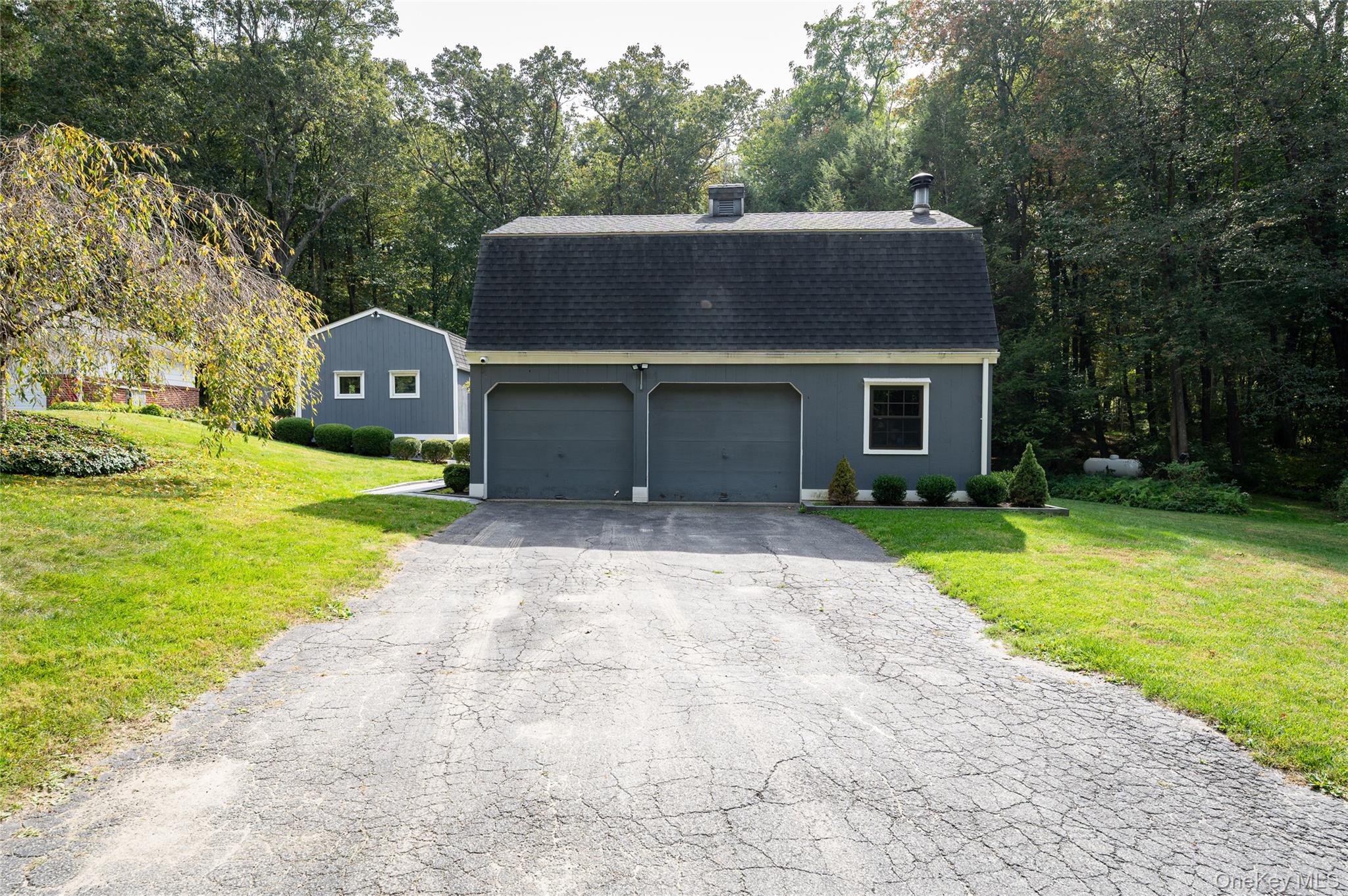 28 Alice Road Mount Kisco, NY 10549 - Photo 30 of 32 a front view of a house with a yard and garage