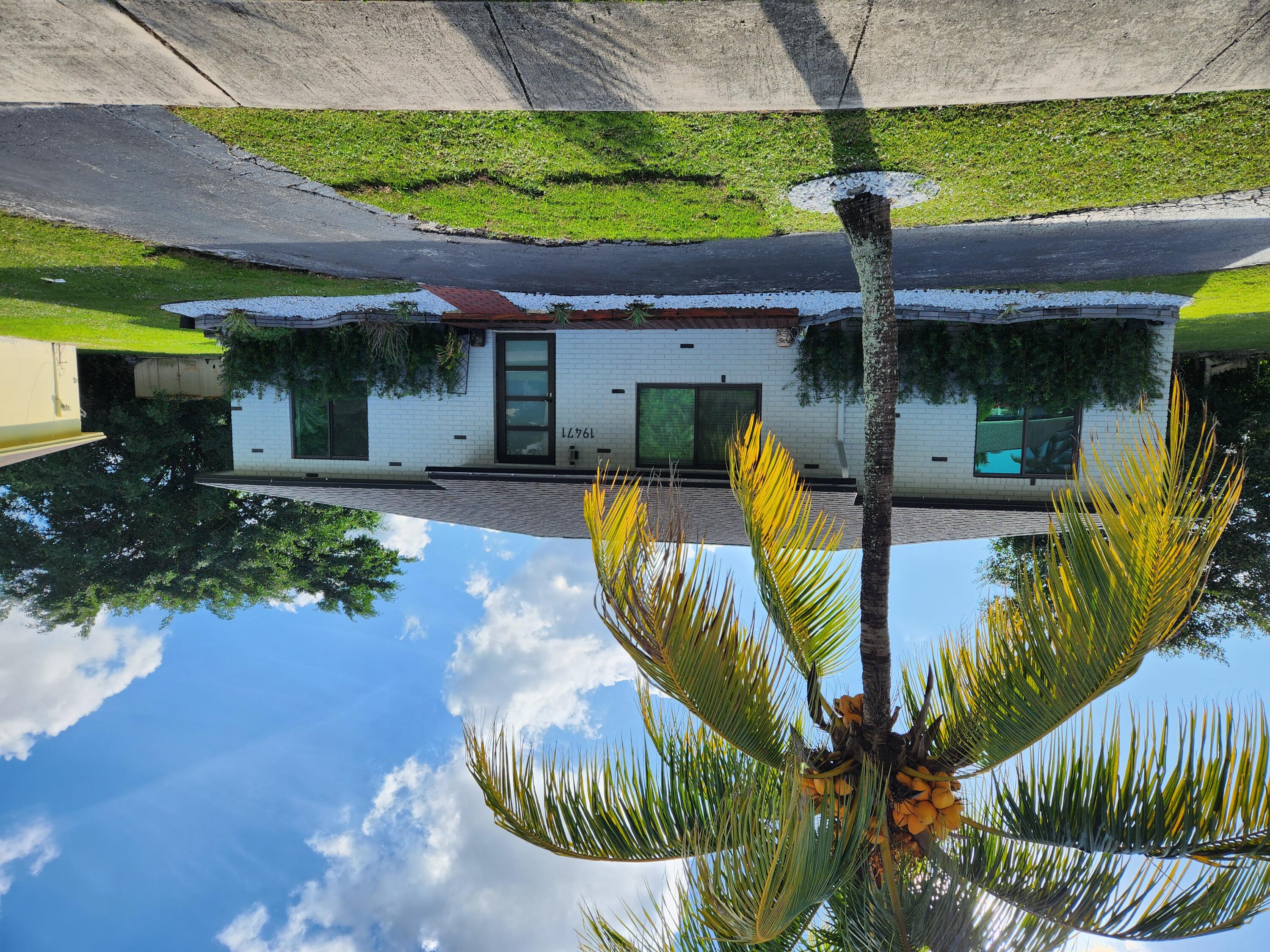 a front view of house with yard and tree