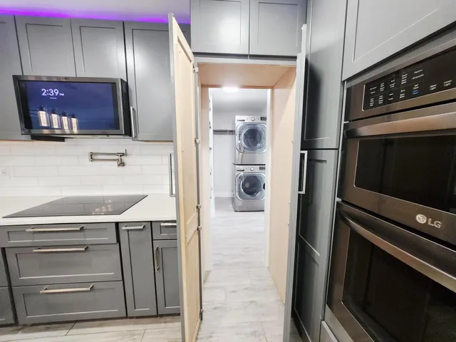a kitchen with a refrigerator and cabinets