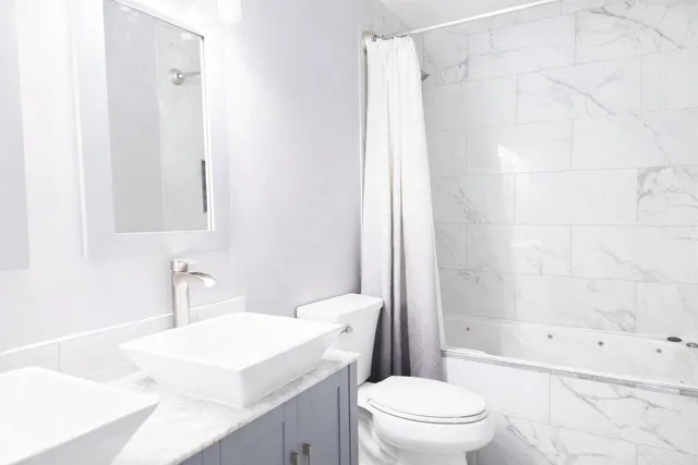 a bathroom with a sink a toilet and a bathtub