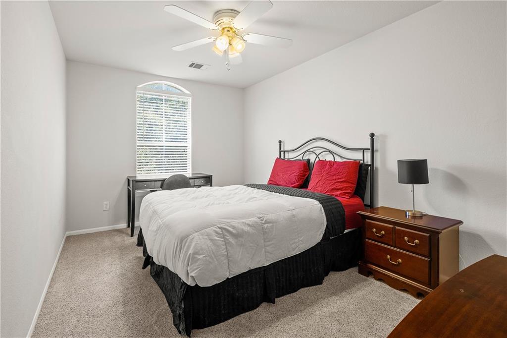 3508 Bratton Ridge Crossing Austin, TX 78728 - Photo 14 of 18 An inviting bedroom with plush carpeting and a large window, ready for personalization.