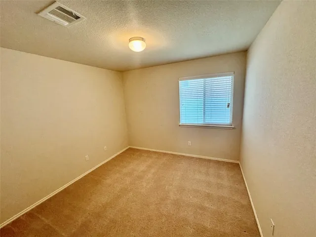 an empty room with a empty space and a window