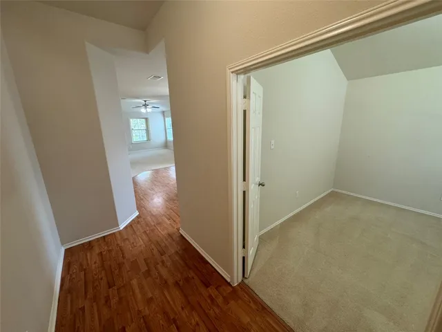 a view of hallway with wooden floor