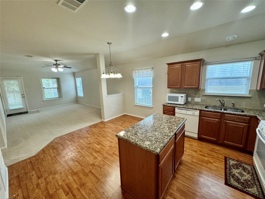 2209 Christoff Loop Austin, TX 78748 - Photo 5 of 25 a kitchen with stainless steel appliances granite countertop sink stove and refrigerator