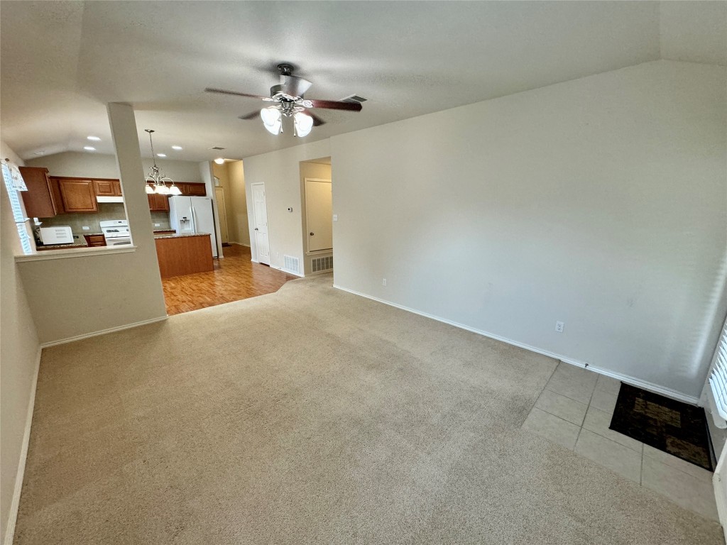 2209 Christoff Loop Austin, TX 78748 - Photo 9 of 25 a view of a livingroom with a ceiling fan and kitchen view