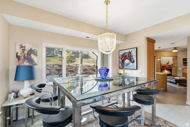 7930 Mustang Loop Road Park City, UT 84098 - Photo 4 of 23 Dining room featuring light carpet and a large fireplace