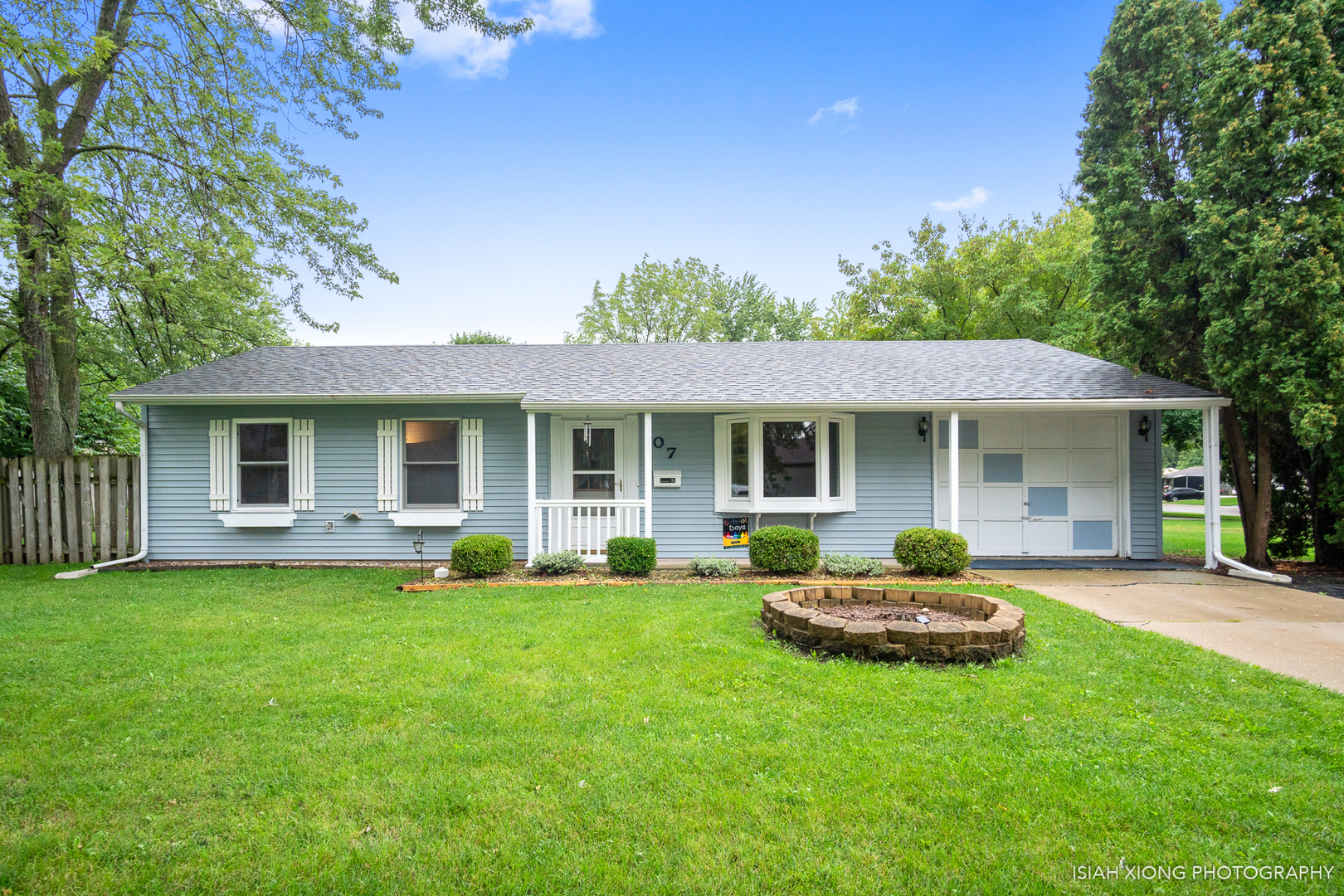 107 Long Beach Road Montgomery, IL 60538 - Photo 1 of 26 a front view of a house with a garden and porch