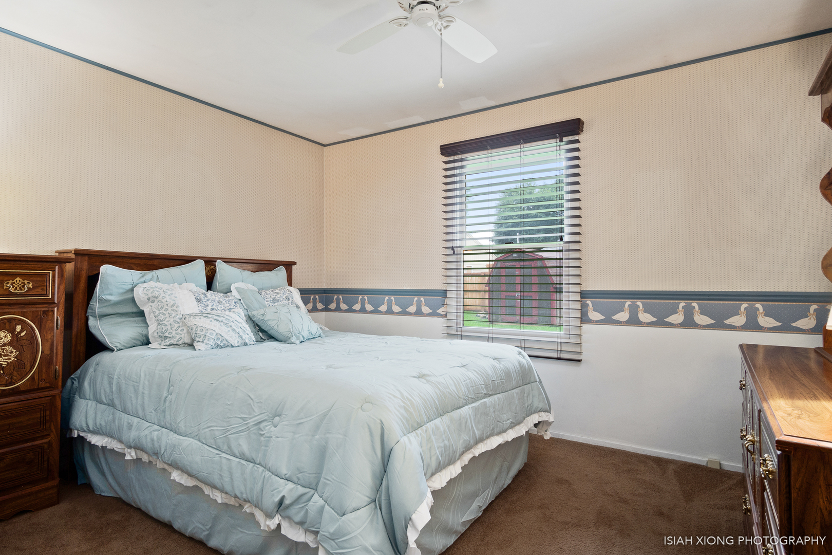 107 Long Beach Road Montgomery, IL 60538 - Photo 17 of 26 a bedroom with a bed and a chandelier