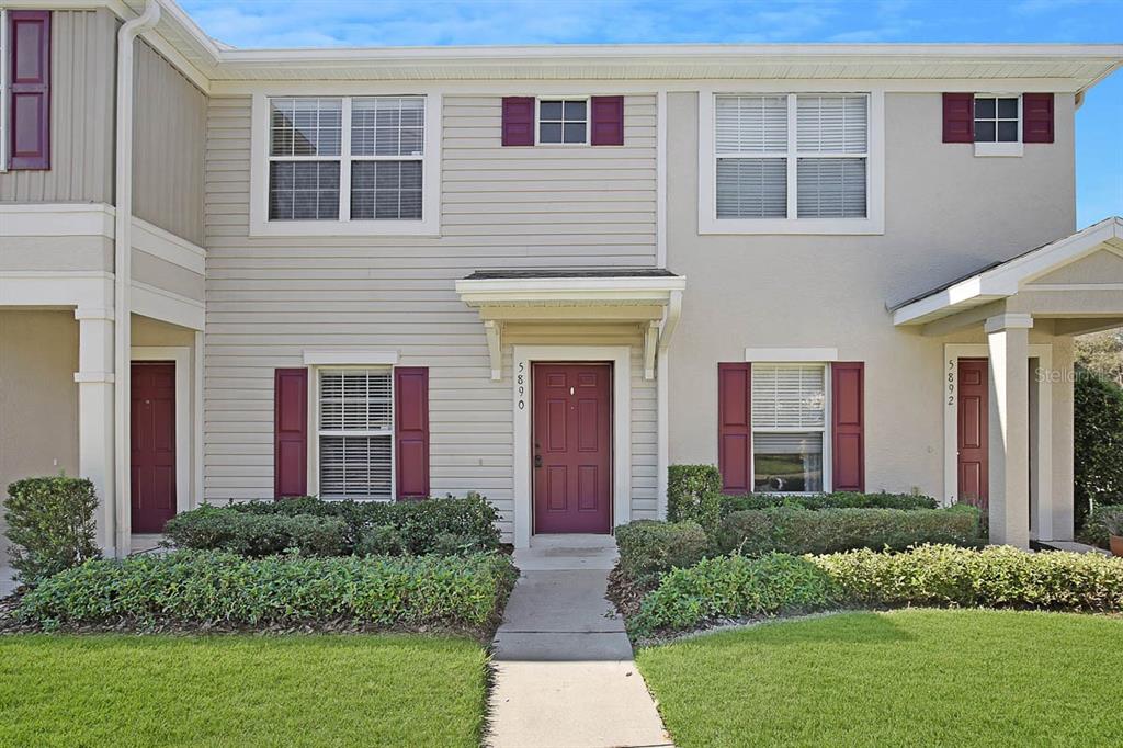a front view of brick house with a yard