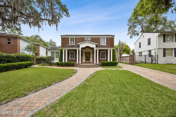 a front view of a house with a garden