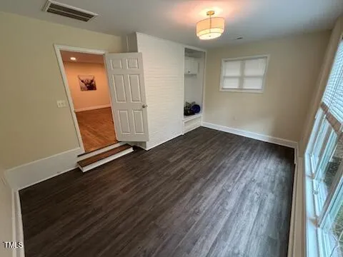 wooden floor in an empty room with a window