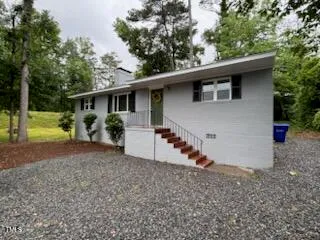 a view of a house with a yard and plants