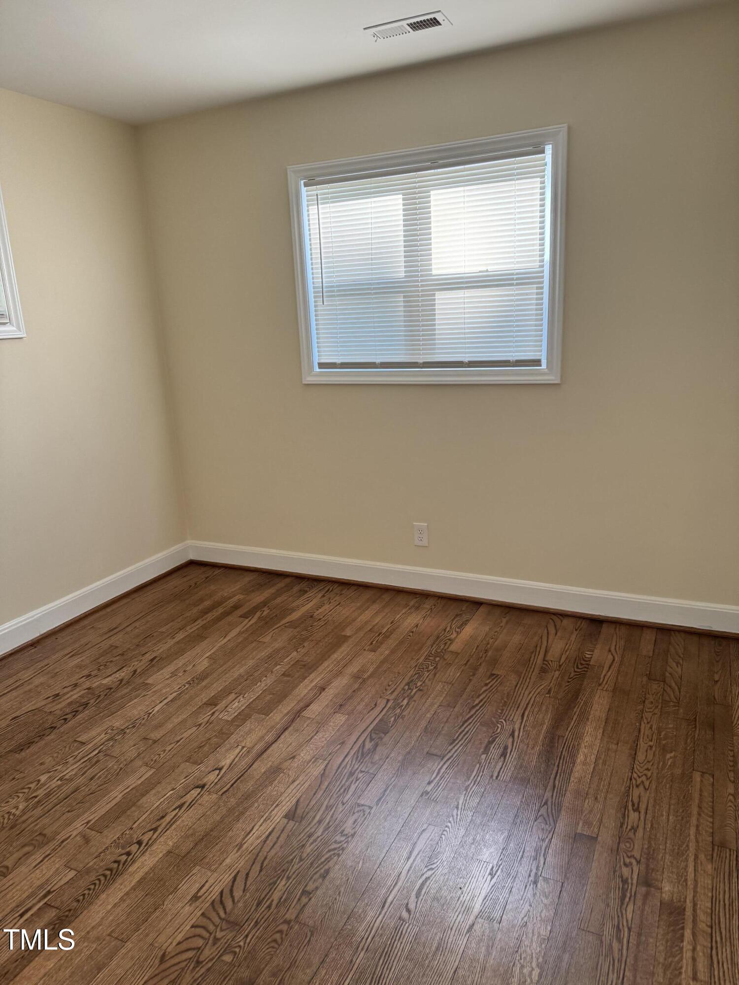 101 Newell Street Durham, NC 27705 - Photo 21 of 29 a view of an empty room with wooden floor and a window
