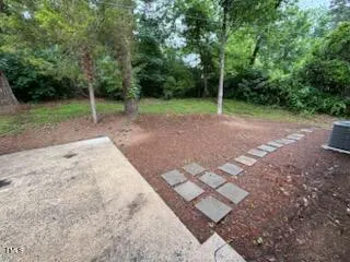 a view of a backyard with wooden fence
