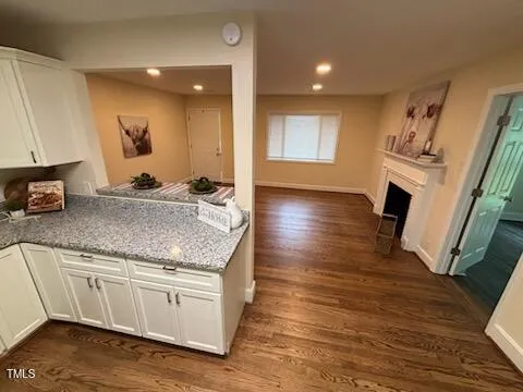 a kitchen with sink cabinets and wooden floor