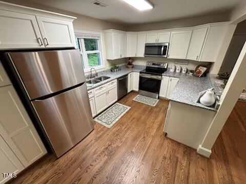 101 Newell Street Durham, NC 27705 - Photo 9 of 29 a kitchen with granite countertop a refrigerator a sink dishwasher a stove and a refrigerator with wooden floor