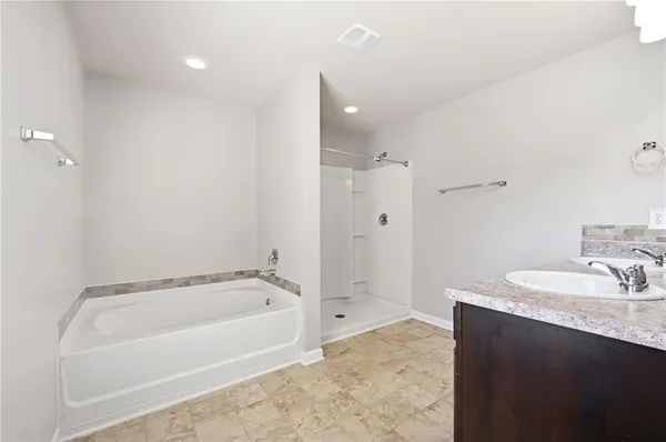 a bathroom with a bathtub and a sink