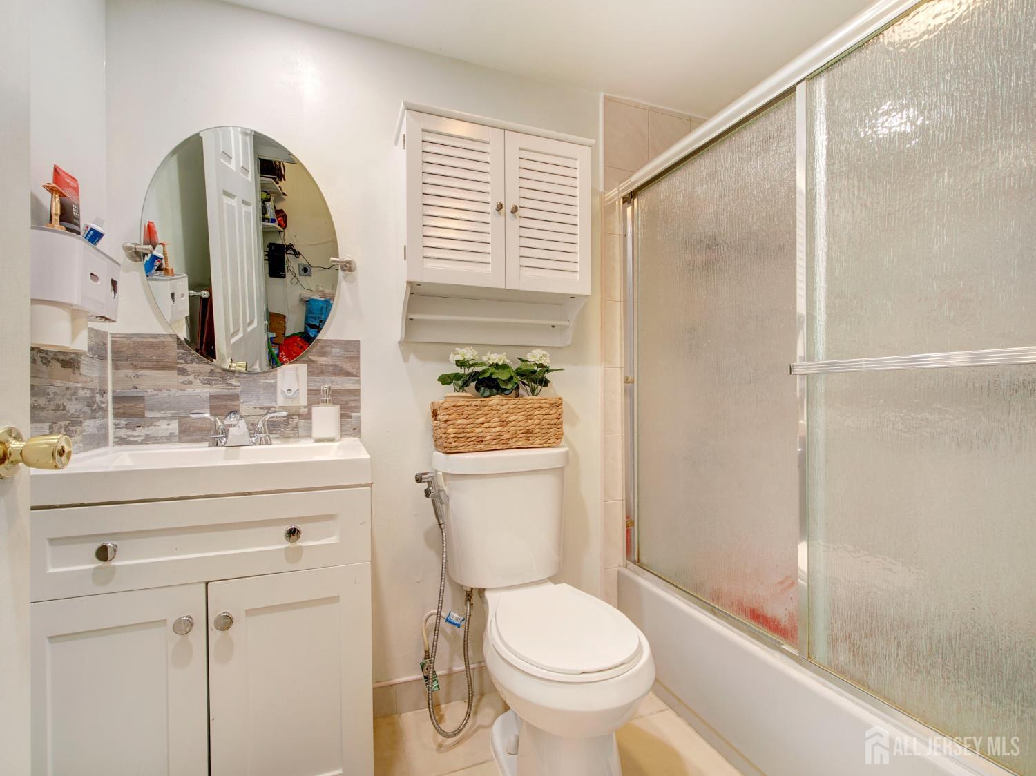 267 Watson Avenue Perth Amboy, NJ 08861 - Photo 20 of 24 a bathroom with a toilet a sink and a mirror