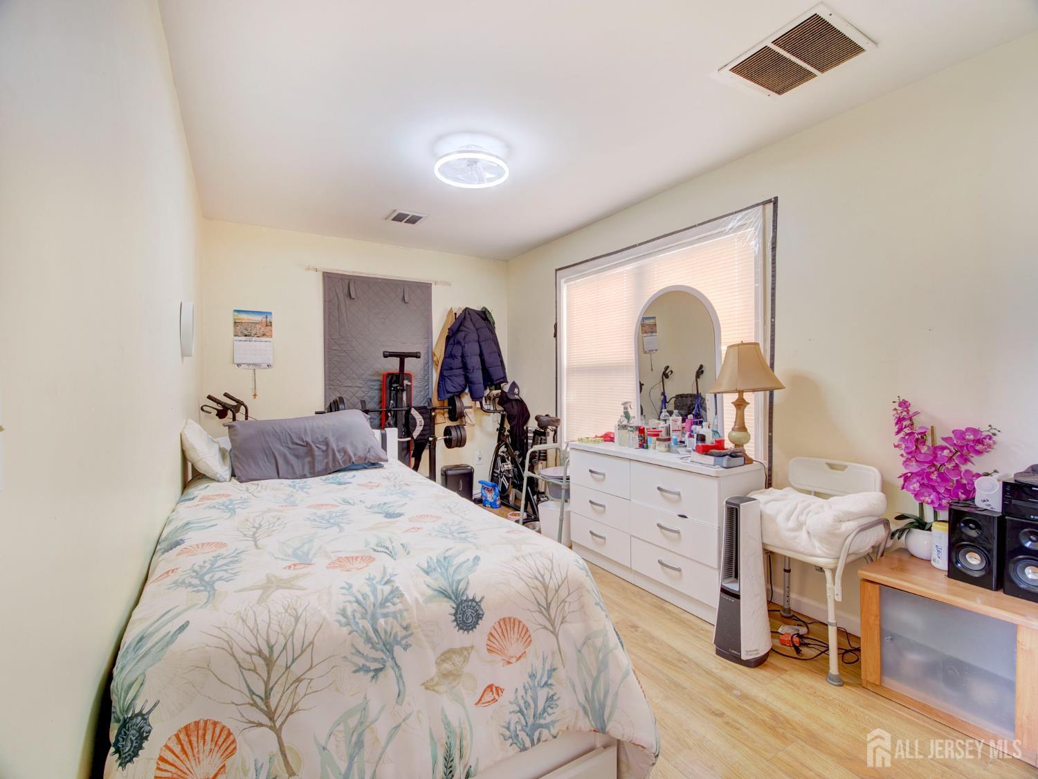 267 Watson Avenue Perth Amboy, NJ 08861 - Photo 10 of 24 a bed room with a bed mirror and desk