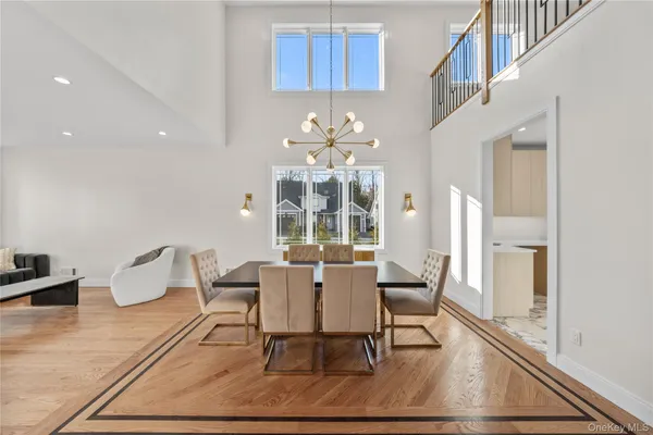 a view of a dining room with furniture a rug and wooden floor