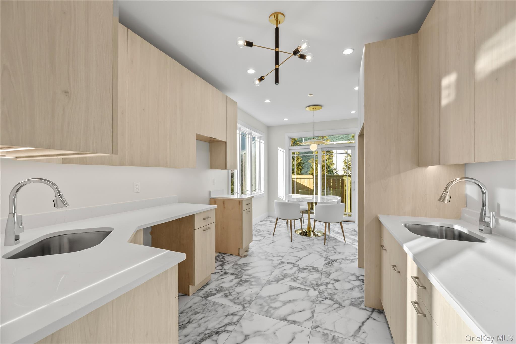 57 Dessau Circle Spring Valley, NY 10977 - Photo 19 of 48 Kitchen with light brown cabinets, modern cabinets, light stone countertops, light marble finish flooring, and a chandelier