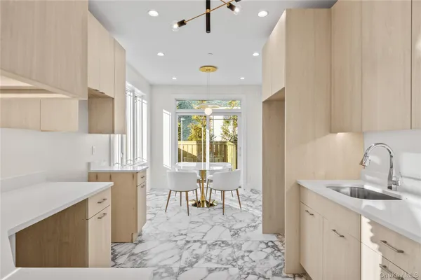 a kitchen with a sink a counter top space and stainless steel appliances