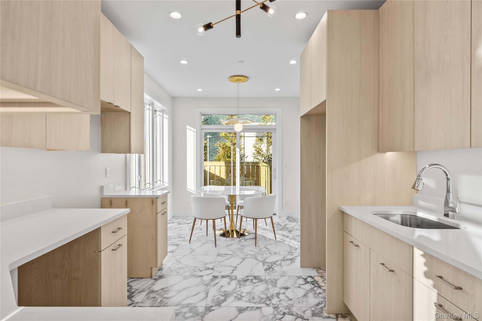 57 Dessau Circle Spring Valley, NY 10977 - Photo 20 of 48 Kitchen featuring light brown cabinetry, modern cabinets, recessed lighting, pendant lighting, and light stone countertops