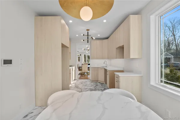 a bedroom with a bed mirror and a window