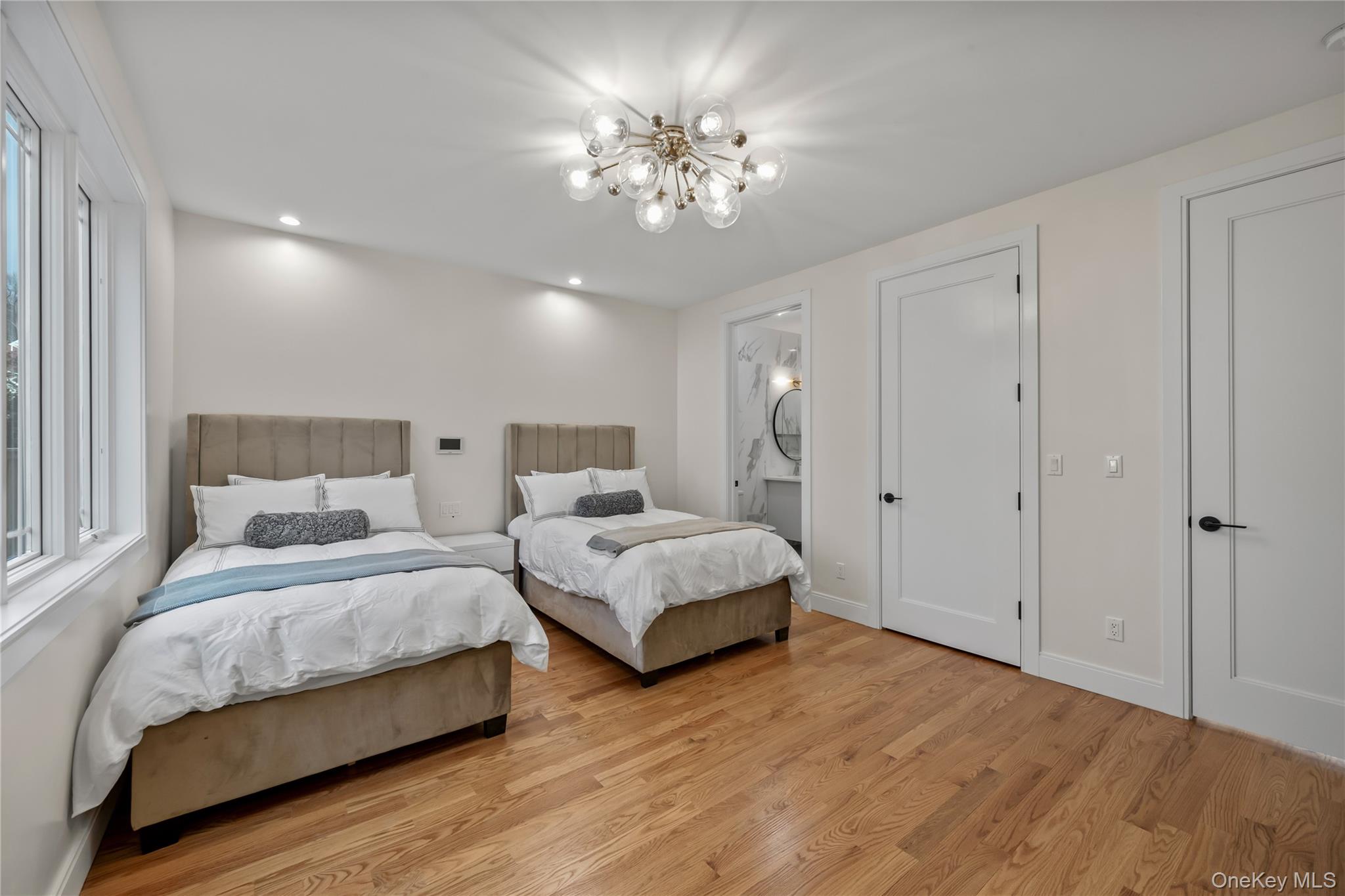 57 Dessau Circle Spring Valley, NY 10977 - Photo 27 of 48 Bedroom with light wood-style flooring, recessed lighting, ensuite bathroom, and a chandelier