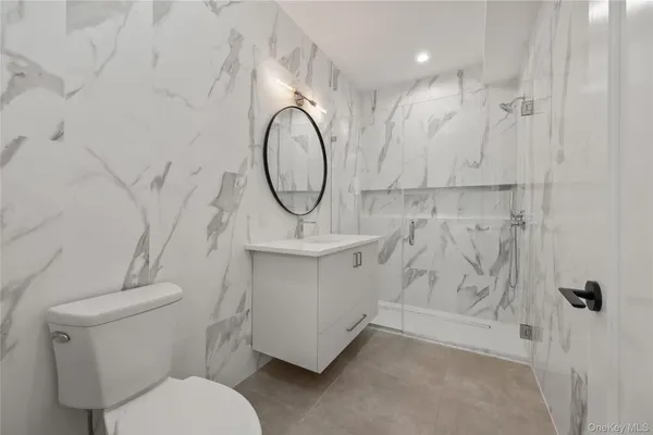 a bathroom with a toilet sink and shower