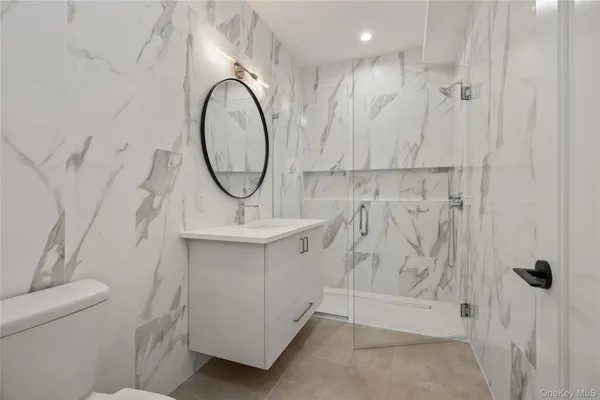 a bathroom with a sink a toilet and a mirror