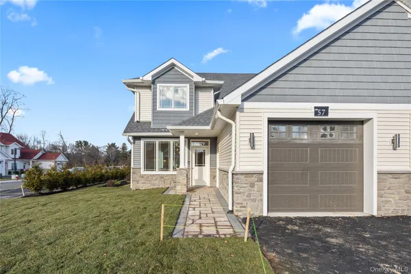a front view of a house with a yard