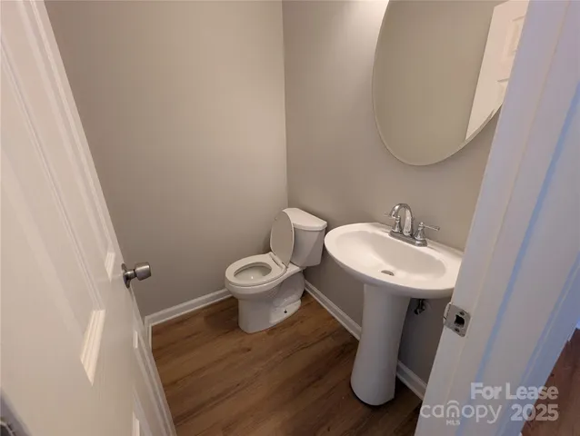 a white toilet sitting next to a bathroom sink