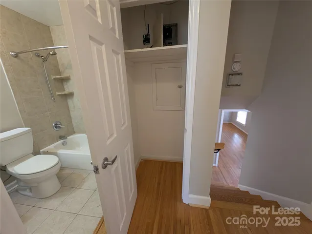 a bathroom with a toilet and a shower