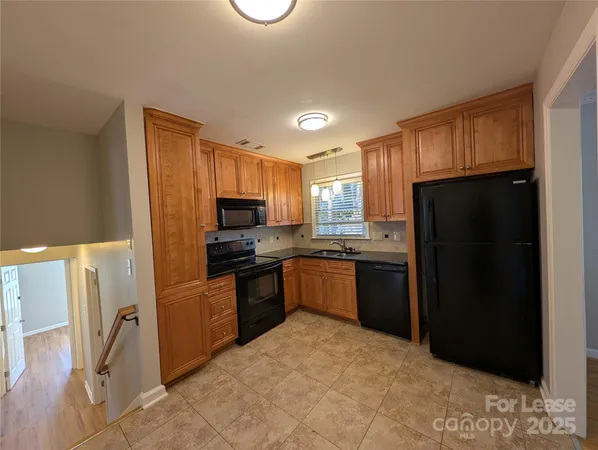 a kitchen with a refrigerator a stove top oven a sink and dishwasher