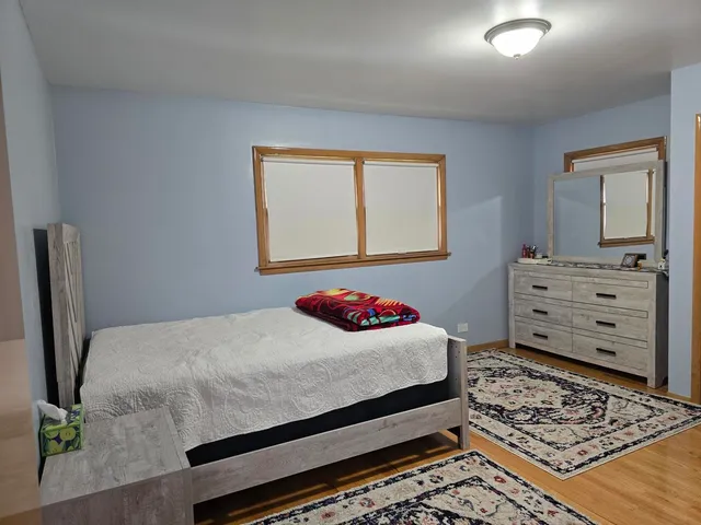 a bedroom with a bed and dresser