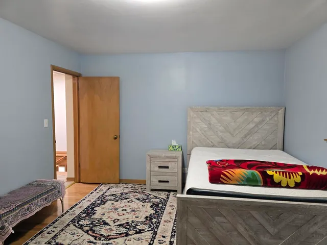 a bedroom with a bed and a couch