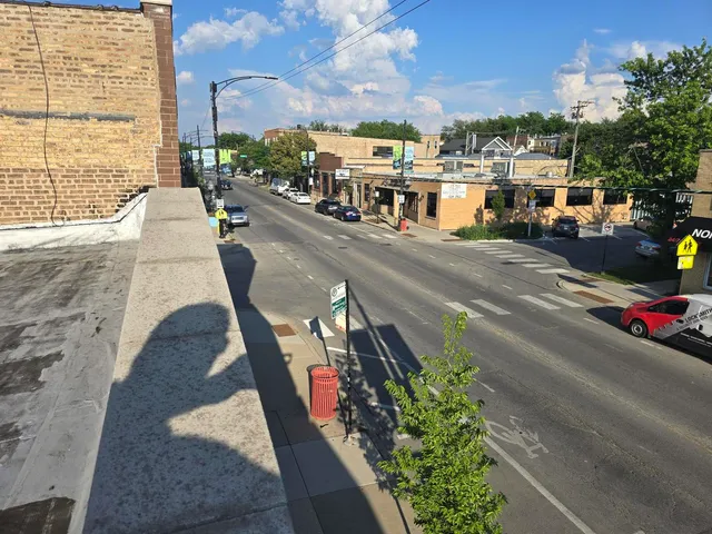 a city street with cars parked in front of it