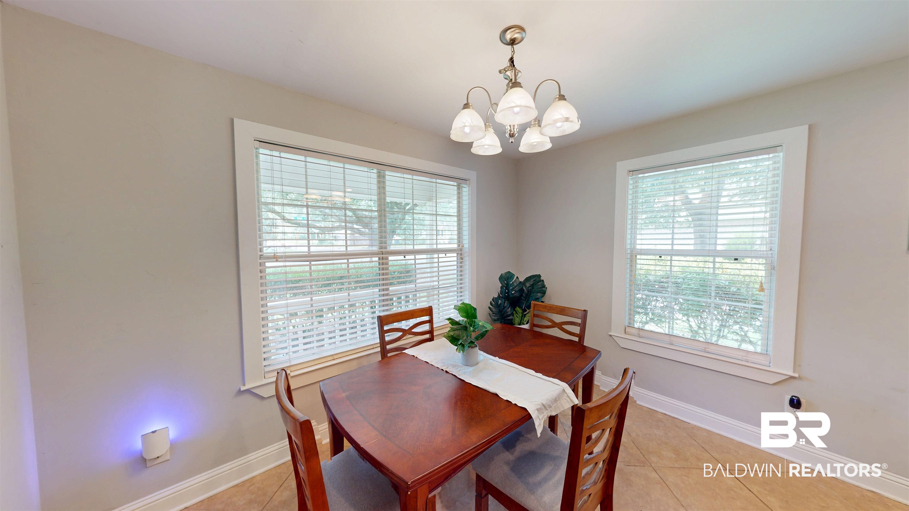 51 Bishop Lane South Mobile, AL 36608 - Photo 6 of 19 Dining space with light tile patterned flooring, healthy amount of natural light, and a chandelier