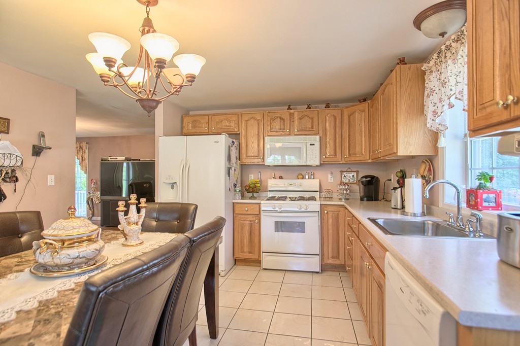 86 Acropolis Road Lowell, MA 01854 - Photo 12 of 30 a kitchen with a sink stove and refrigerator