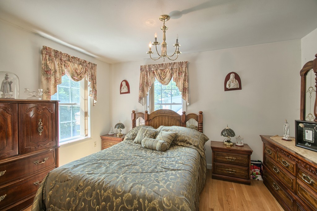 86 Acropolis Road Lowell, MA 01854 - Photo 16 of 30 a bed room with a bed and a television