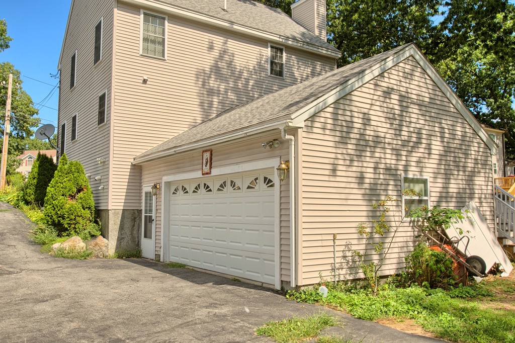 86 Acropolis Road Lowell, MA 01854 - Photo 24 of 30 a view of a house with a garage