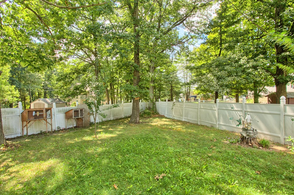86 Acropolis Road Lowell, MA 01854 - Photo 27 of 30 a backyard of a house with table and chairs