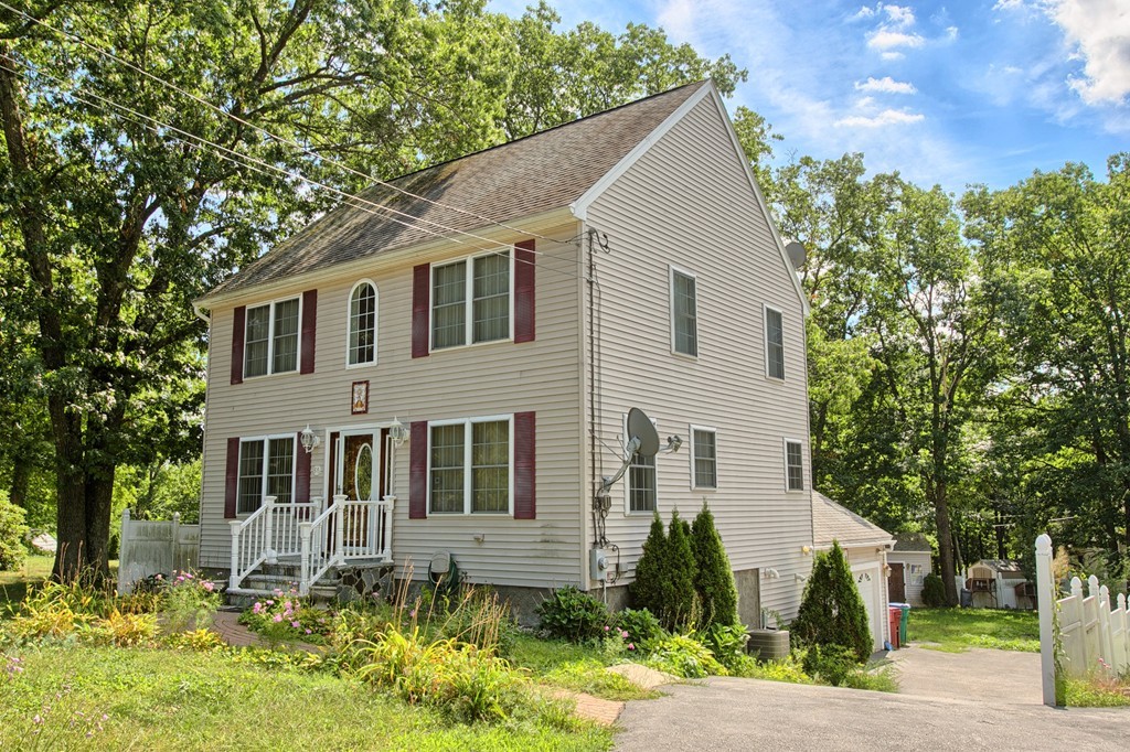 86 Acropolis Road Lowell, MA 01854 - Photo 3 of 30 a front view of a house with a yard